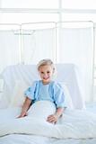Smiling blond girl on a hospital bed