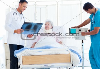 Smiling doctor showing an x-ray to a female patient