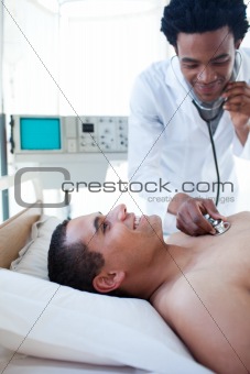 A doctor checking the pulse on a male patient