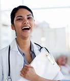 Laughing doctor holding a medical clipboard