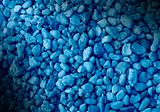 Smooth blue pebble background dramatically lit.