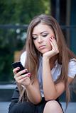 young woman looks in phone and longs having seen something on th