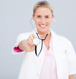 Smiling female doctor  pointing at the camera 