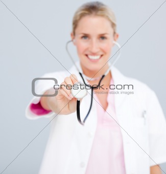Smiling female doctor  pointing at the camera 