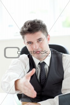 Assertive businessman  holding out his hand