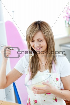 Delighted woman preparing a meal in the kitchen
