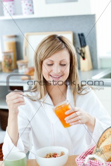 Cute woman having a breakfast in the kitchen