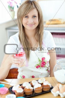 Caucasian woman cooking cakes in the kitchen 