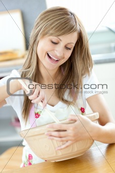 Caucasian woman preparing a cake in the kitchen