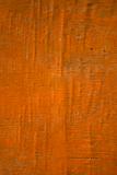 Orange painted old warped plywood 
