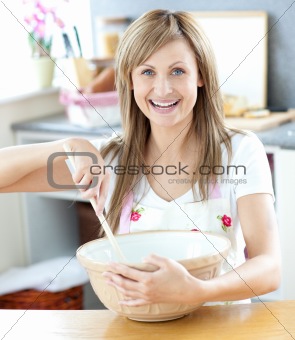 Close-up of a caucasian woman preparing a cake in the kitchen