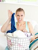 Disgusted woman doing her laundry 