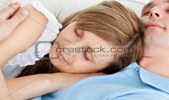 Close-up of a young couple sleeping lying on a sofa