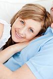 Close-up of a cheerful woman hugging her boyfriend lying on a so