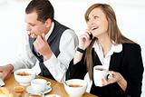 Young couple of business people having breakfast