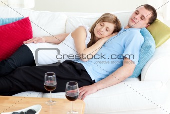 Loving couple sleeping lying on a sofa