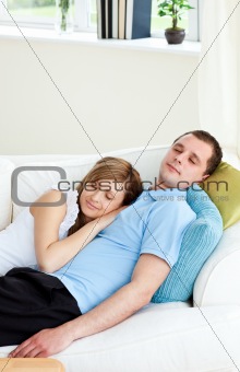 Affectionate couple sleeping lying on a sofa