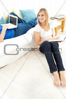 Smiling couple having free time in the living-room 