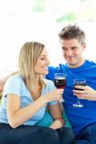 Adorable couple drinking wine together in the living-room 