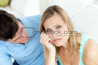 Sad couple having an argue in the living-room 