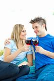 Beautiful couple drinking wine together in the living-room 