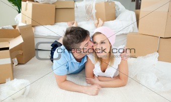 Enamored couple relaxing after moving 