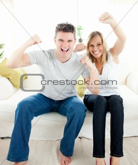 Charming couple having free time together in the living-room