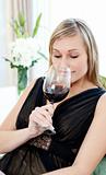 Charming blond woman drining red wine