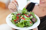 Close-up of a woman eating a salad
