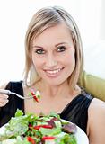 Portrait of a bright woman eating a salad