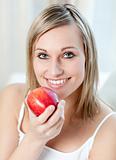 Smiling woman eating an apple 