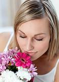 Beautiful woman smelling a bunch of flowers 