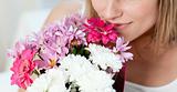Close-up of a woman smelling a bunch of flowers 