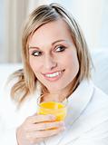 Portrait of a charming woman holding an orange juice