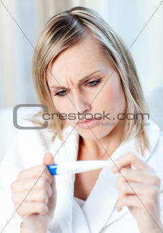 Worried woman finding out the results of a pregnancy test 