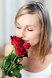 Beautiful woman smelling roses 
