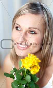 Portrait of a charming woman holding yellow roses