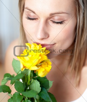 Attractive woman smelling roses 