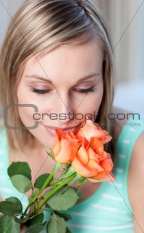 Charming woman smelling roses 