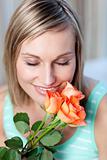 Cheerful woman smelling roses