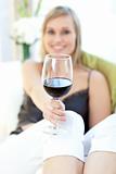 Radiant woman drinking red wine 