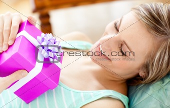 Happy woman holding a present 