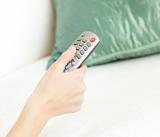 Cllose-up of a woman holding a remote 