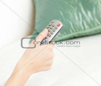 Cllose-up of a woman holding a remote 