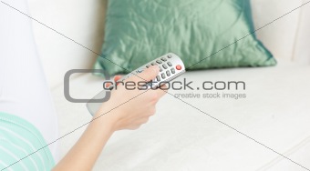 Cllose-up of a Caucasian woman holding a remote