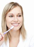 Radiant woman holding a toothbrush 