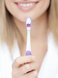 Close-up of a woman holding a toothbrush 