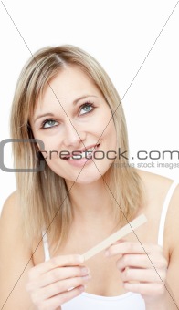 Portrait of a pensive woman filing her nails