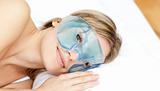 Peaceful woman with an eye gel mask