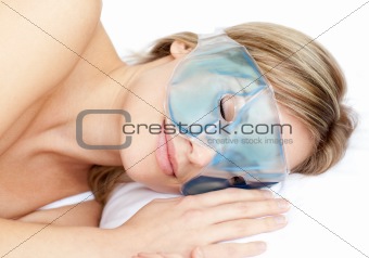 Dreamy woman with an eye gel mask